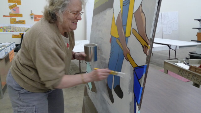 Painting of the mural Eugene Habitat ReStore Volunteer